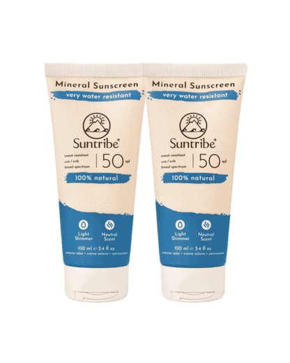 Two tubes of Suntribe Mineral Sunscreen on a green background